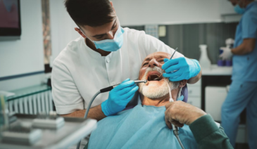 Dentist cleaning patient's teeth.