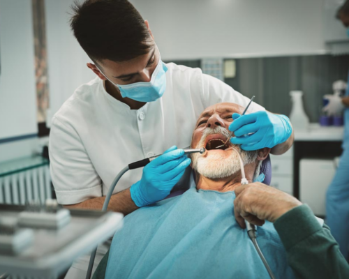 Dentist cleaning patient's teeth.