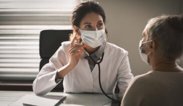 Masked woman and doctor in consultation