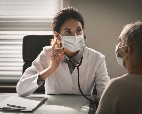 Masked woman and doctor in consultation