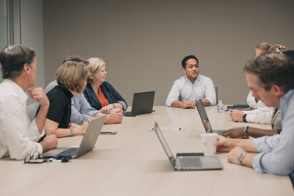 A group of GoHealth employees at a conference table