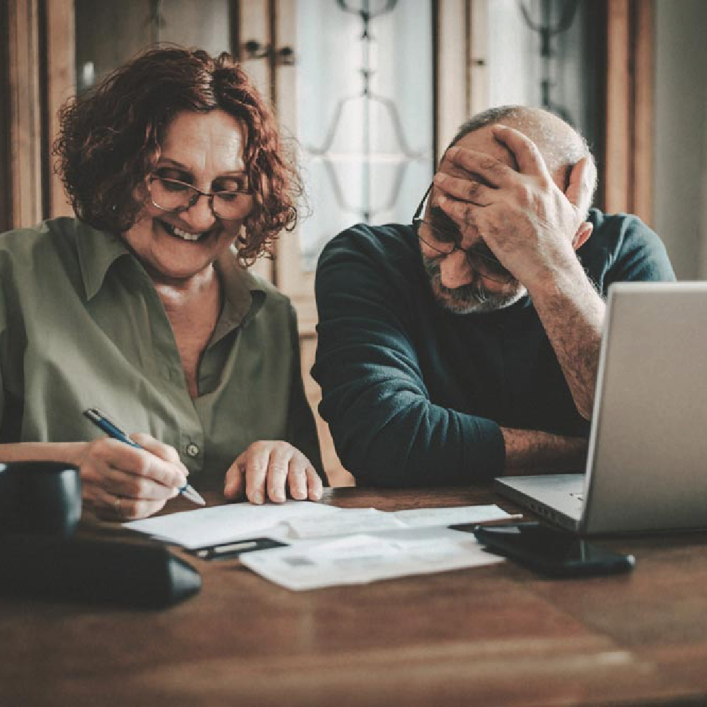 A man and a woman working on Medicare paperwork at a desk