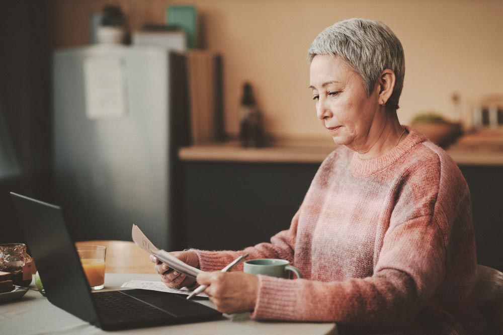 A Medicare recipient researching Medicare on her laptop