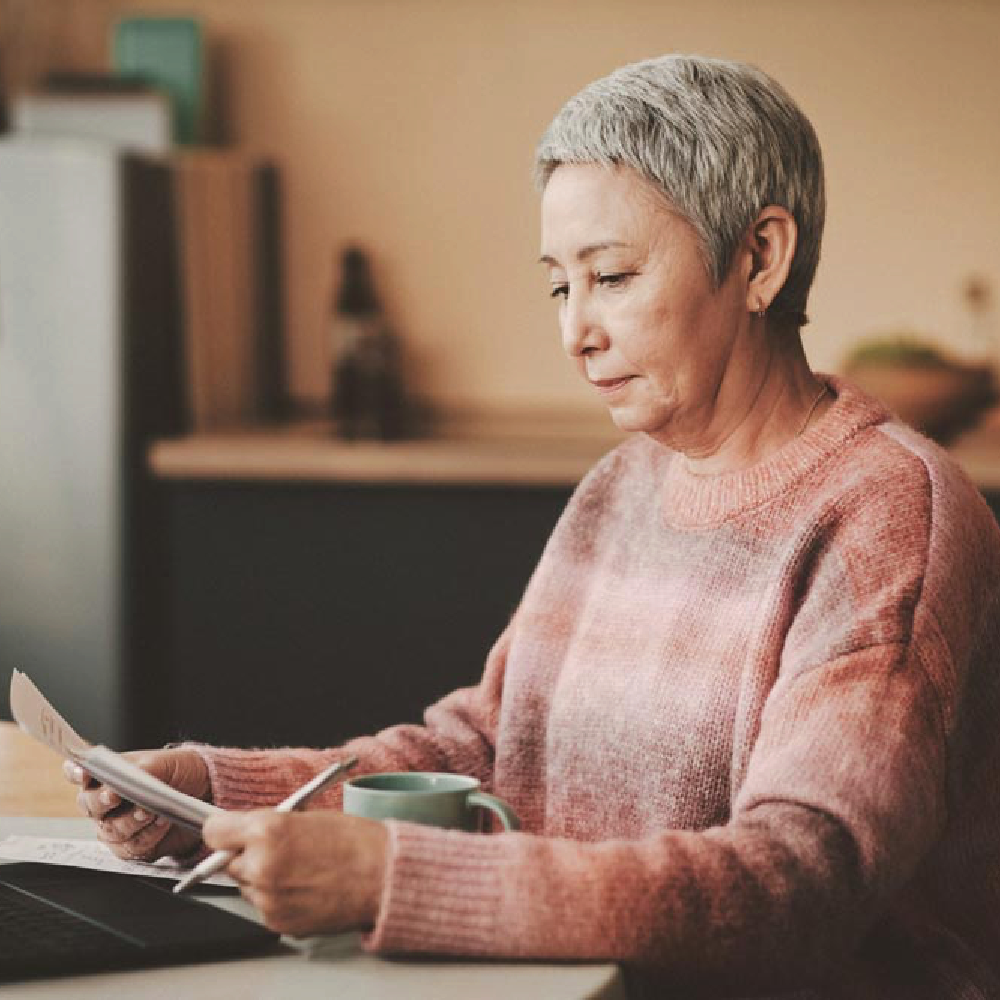 A Medicare recipient researching Medicare on her laptop