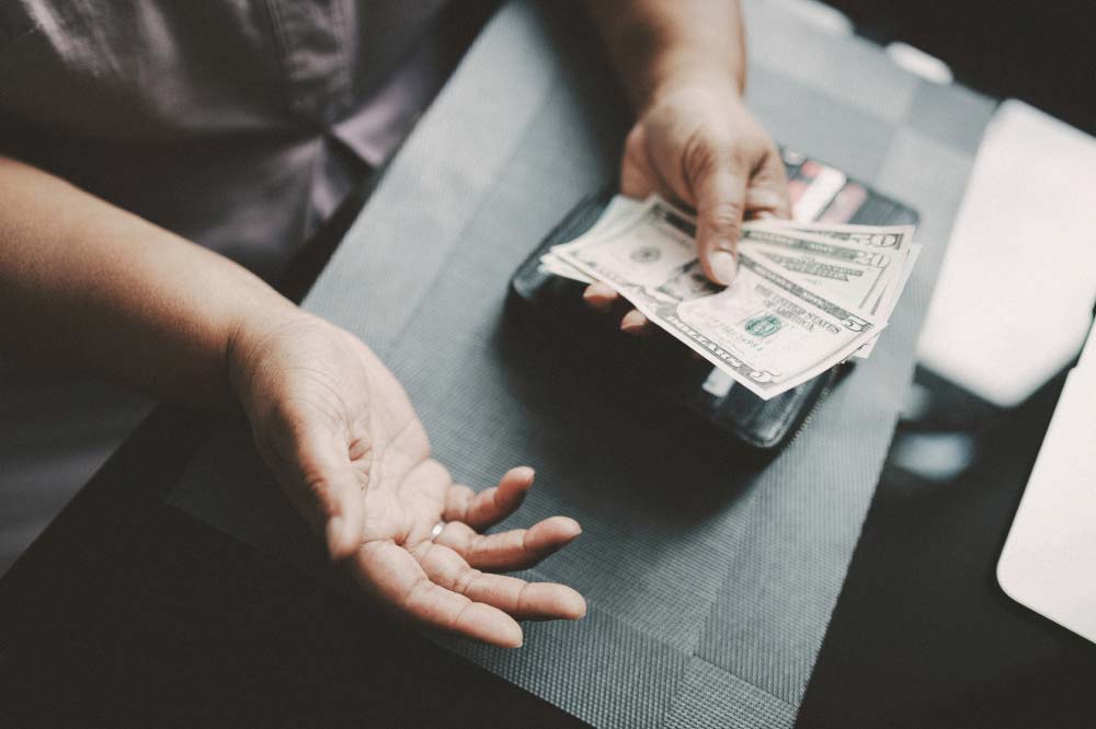 A person with cash in their hands