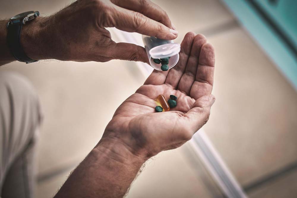 Someone counting out prescription drugs in their hand