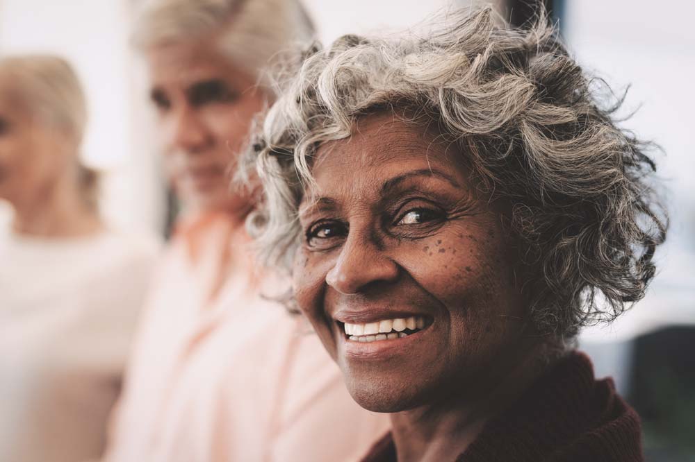 A medicare recipient smiling and looking at the camera