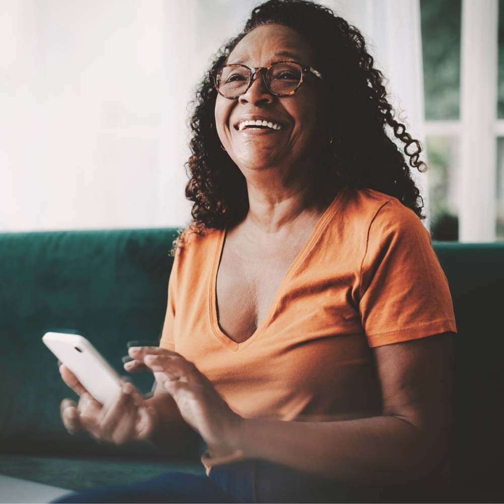 Woman smiling while texting