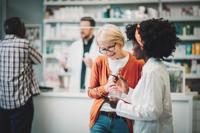 Woman talking to pharmacist.