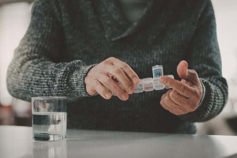 Close up of hands holding a pill organizer