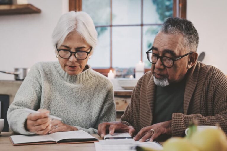 Couple making financial plans at kitchen table.